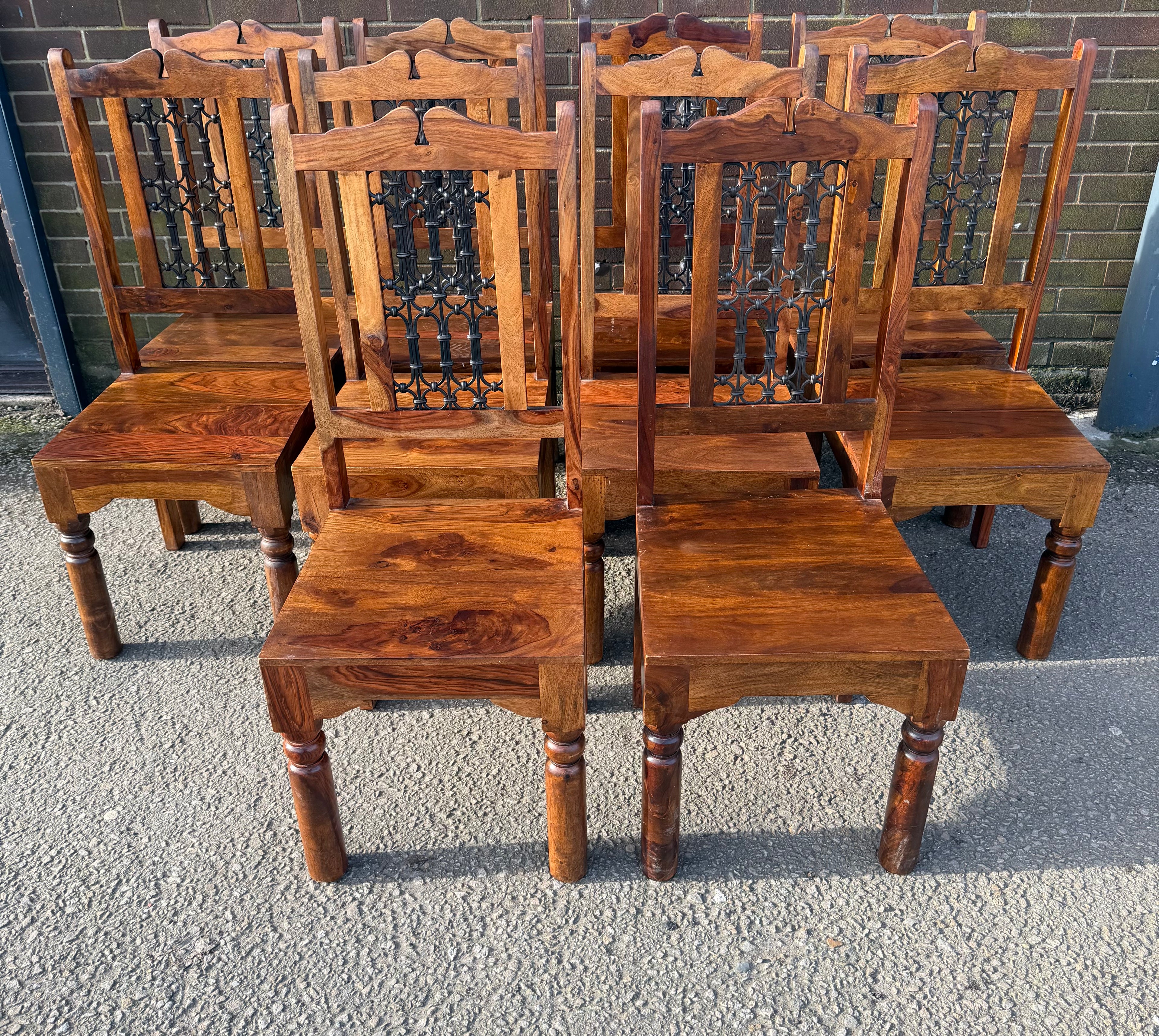 Solid Jali Sheesham wood dining chairs featuring intricate iron portcullis work.